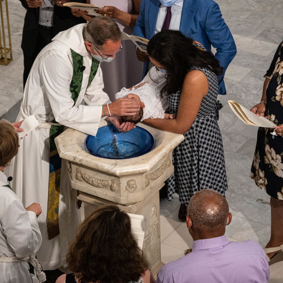 Image of priest baptizing baby.